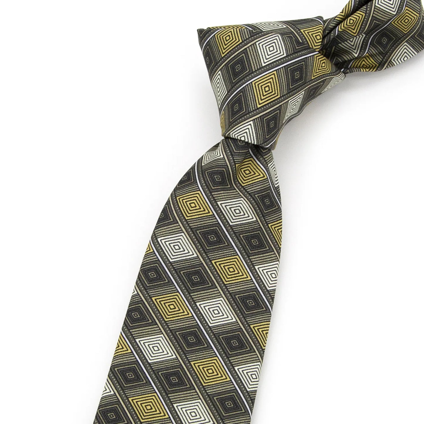 A dark green men's necktie with a repeating geometric diamond pattern in gold and white is loosely knotted against a white background.
