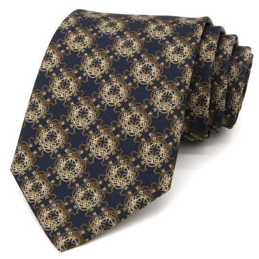 A neatly folded deep blue men's necktie displaying its elegant golden and brown totem geometric pattern against a plain white surface.