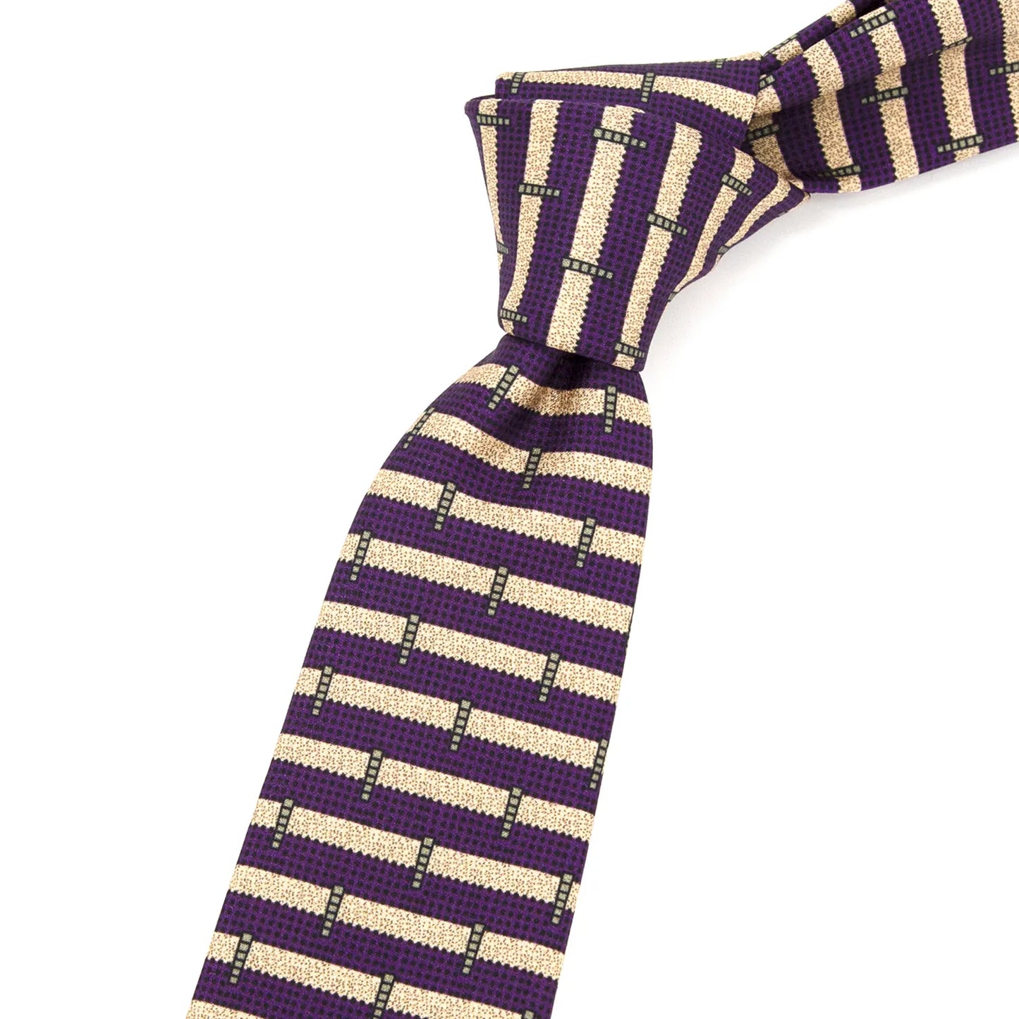 A neatly folded deep purple men's necktie showcasing its contemporary geometric stripe pattern in beige and black against a plain white surface.