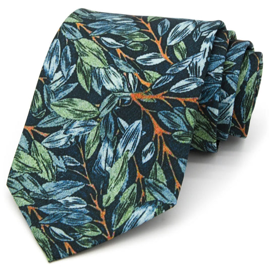 A neatly rolled dark blue men's necktie displaying its artistic leaf motif in green, blue, and brown against a clean white surface.