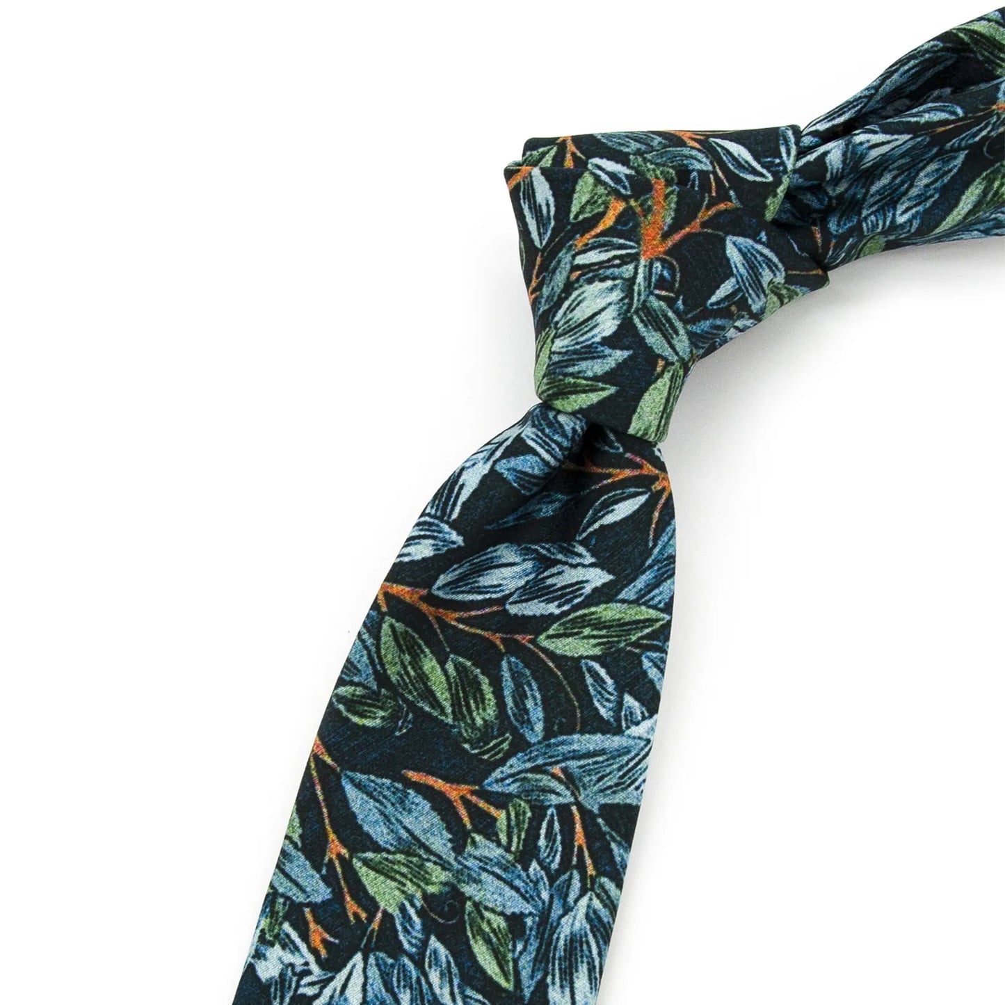 A dark blue men's necktie featuring an artistic leaf print in shades of green, blue, and brown is casually knotted against a white background.
