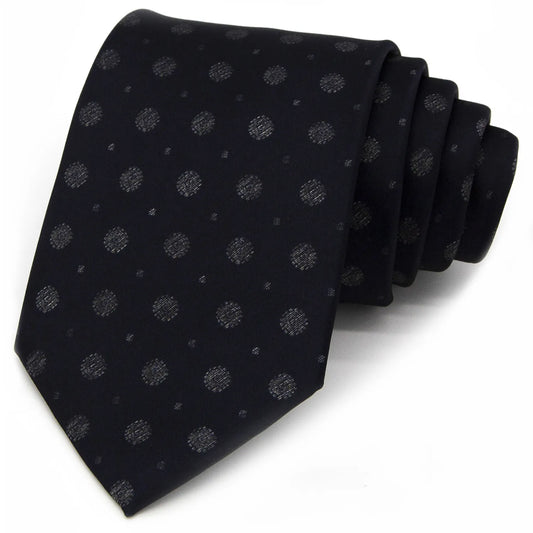 A neatly rolled deep blue men's necktie showcasing its subtle yet textured pattern of small silver-grey dots and mini floral shapes against a clean white backdrop.