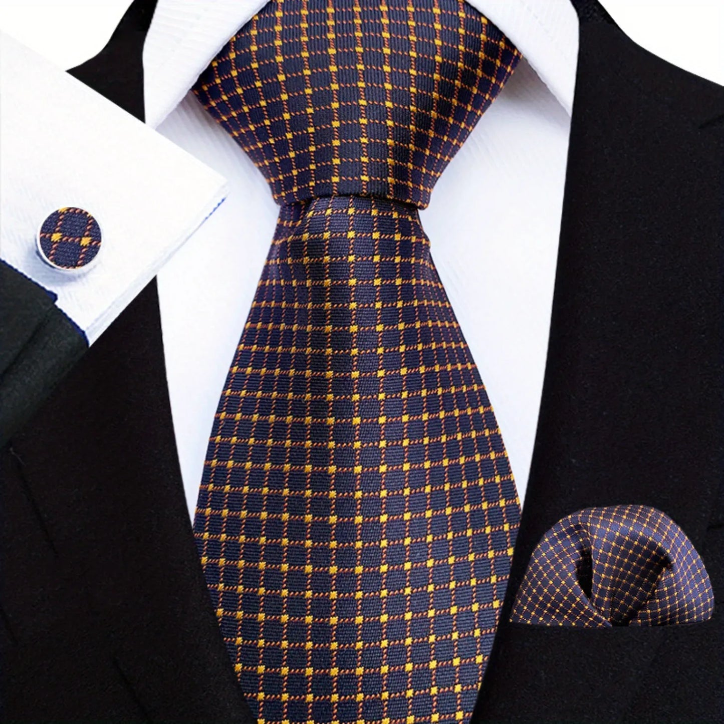 A set consisting of a blue plaid necktie, pocket square, and cufflinks, displayed on a mannequin wearing a black suit and white shirt.