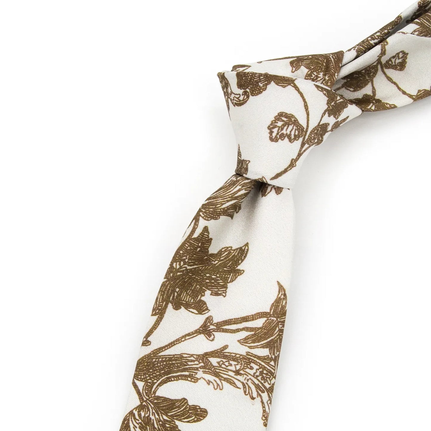 A neatly rolled light off-white men's necktie displaying its subtle floral pattern with brown blooms and foliage against a clean white surface.
