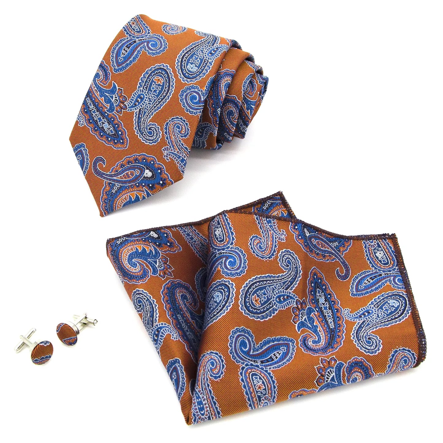A close-up view of a vibrant rust orange and blue paisley patterned polyester tie, expertly knotted, complete with a matching pocket square and cufflinks, styled for a formal occasion.