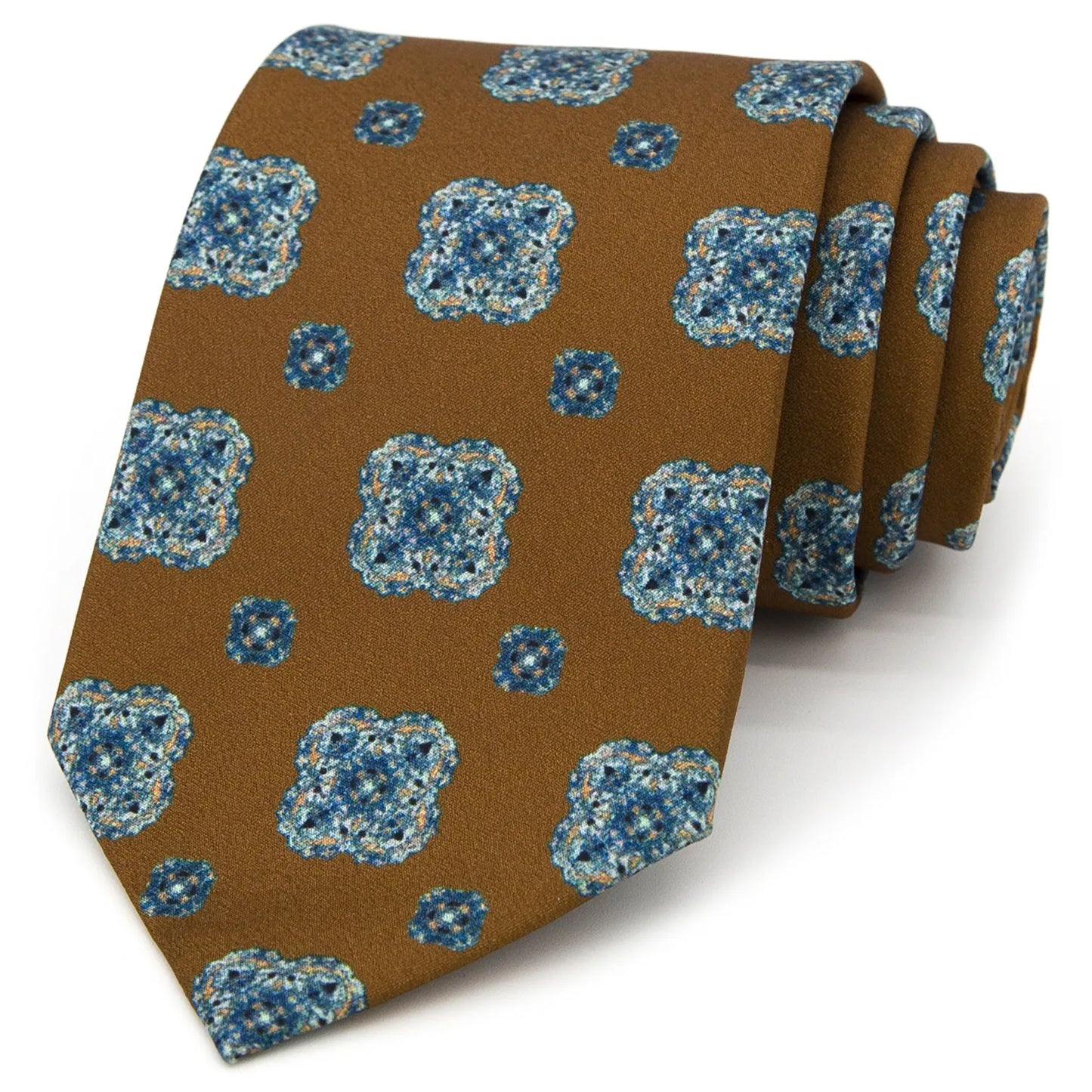A neatly rolled brown men's necktie with a repeating blue and beige floral motif is displayed against a plain white background.