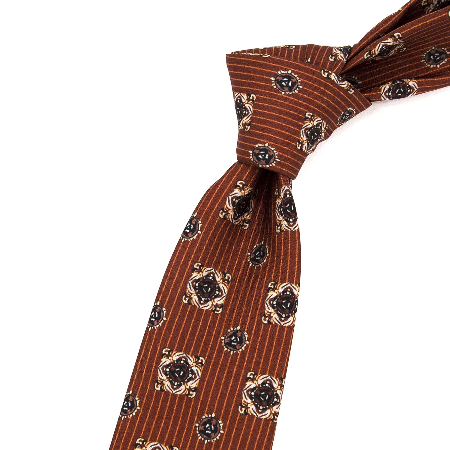 A brown men's necktie featuring a combination of subtle stripes and intricate paisley motifs is loosely knotted against a white background.
