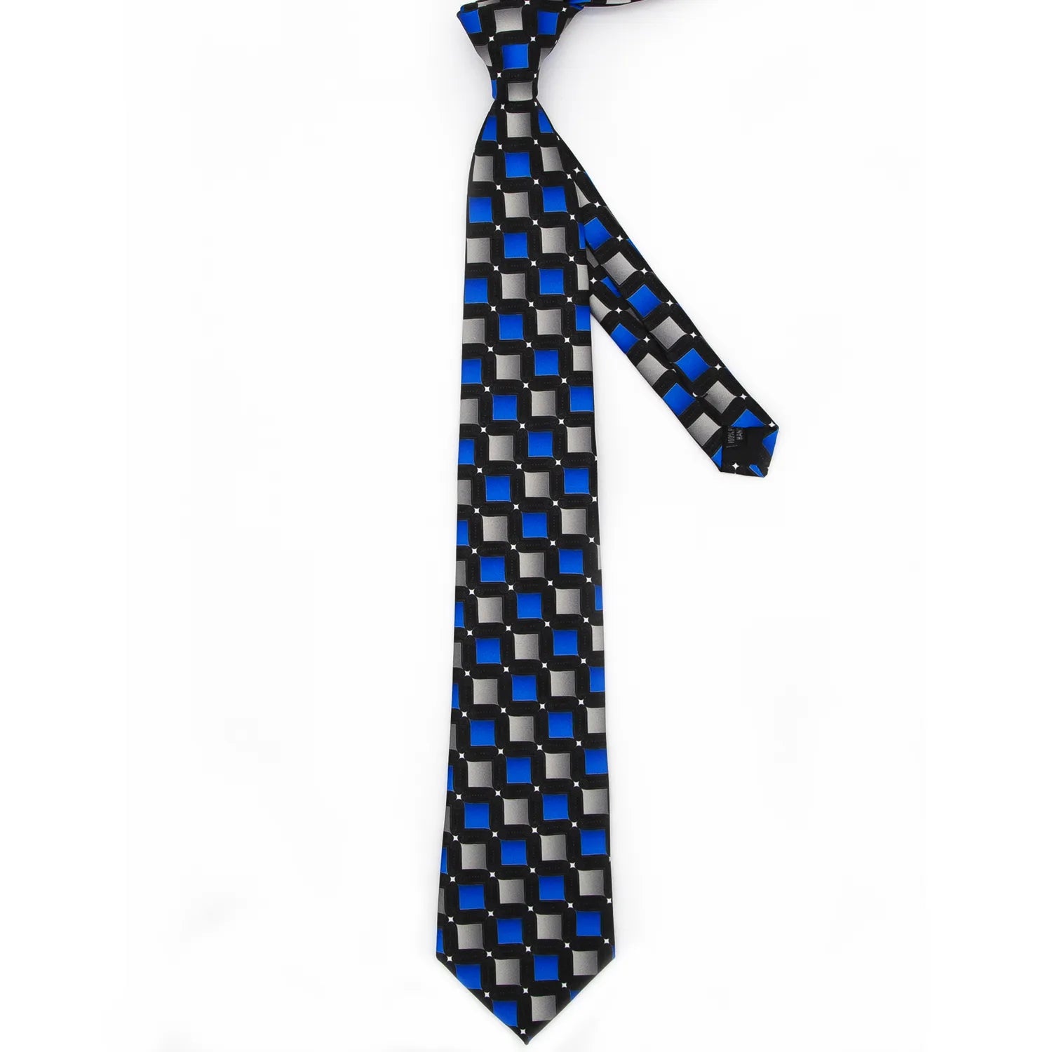 A close-up shows a black men's necktie with a modern geometric square pattern in blue and grey with white dots tied in a knot on a white collared shirt.