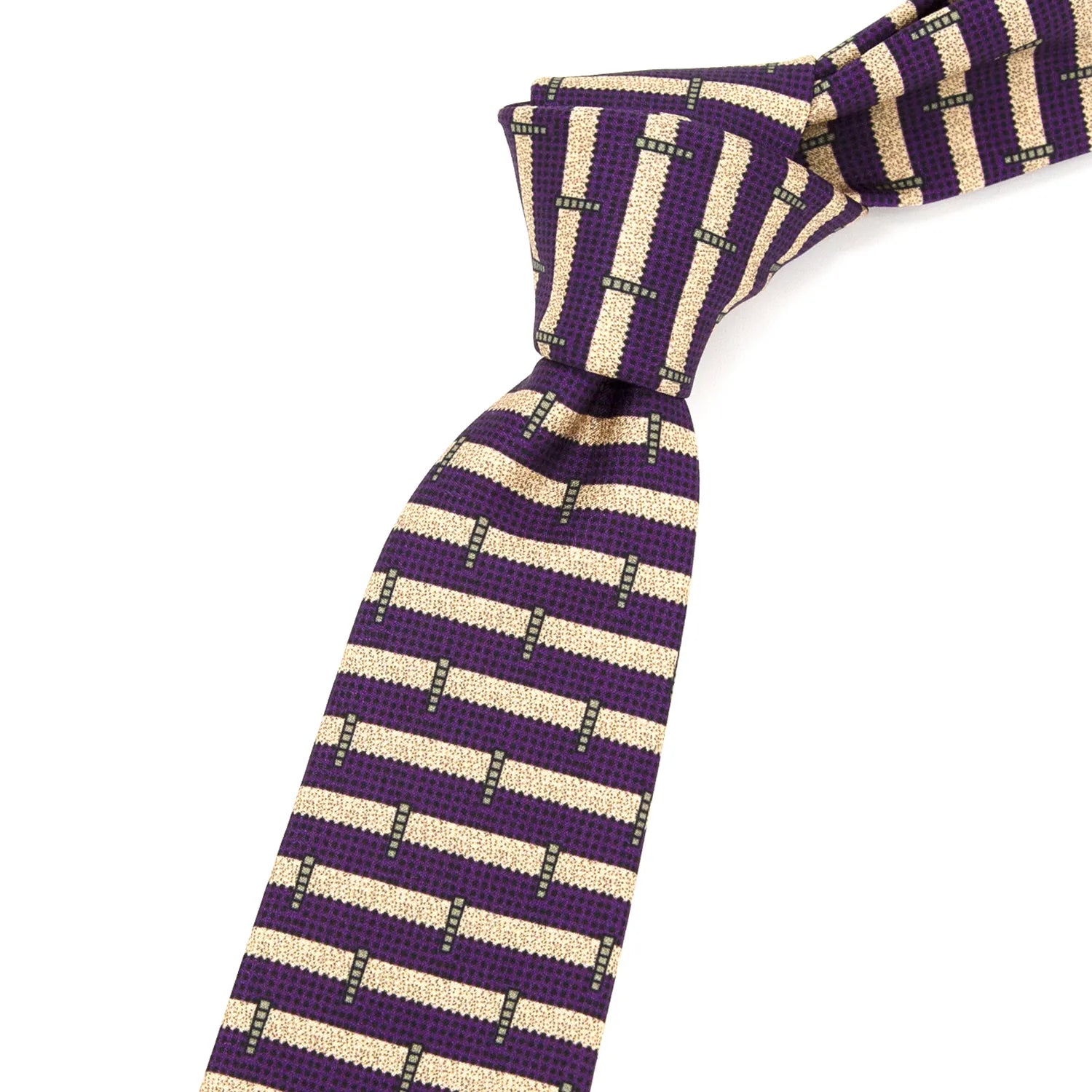 A neatly folded deep purple men's necktie showcasing its contemporary geometric stripe pattern in beige and black against a plain white surface.