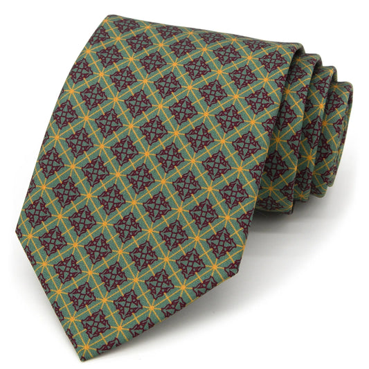 A green men's necktie featuring a vintage-inspired geometric pattern in red and gold is casually knotted against a white background.
