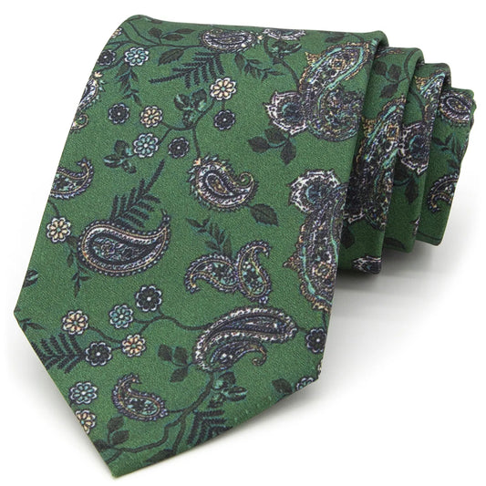 A neatly folded dark blue men's necktie displaying its modern geometric pattern in light blue and white against a clean white surface.