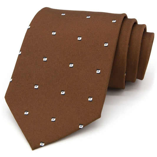 A brown men's necktie featuring a sparse pattern of small white and blue quadrilaterals is casually knotted against a white background.