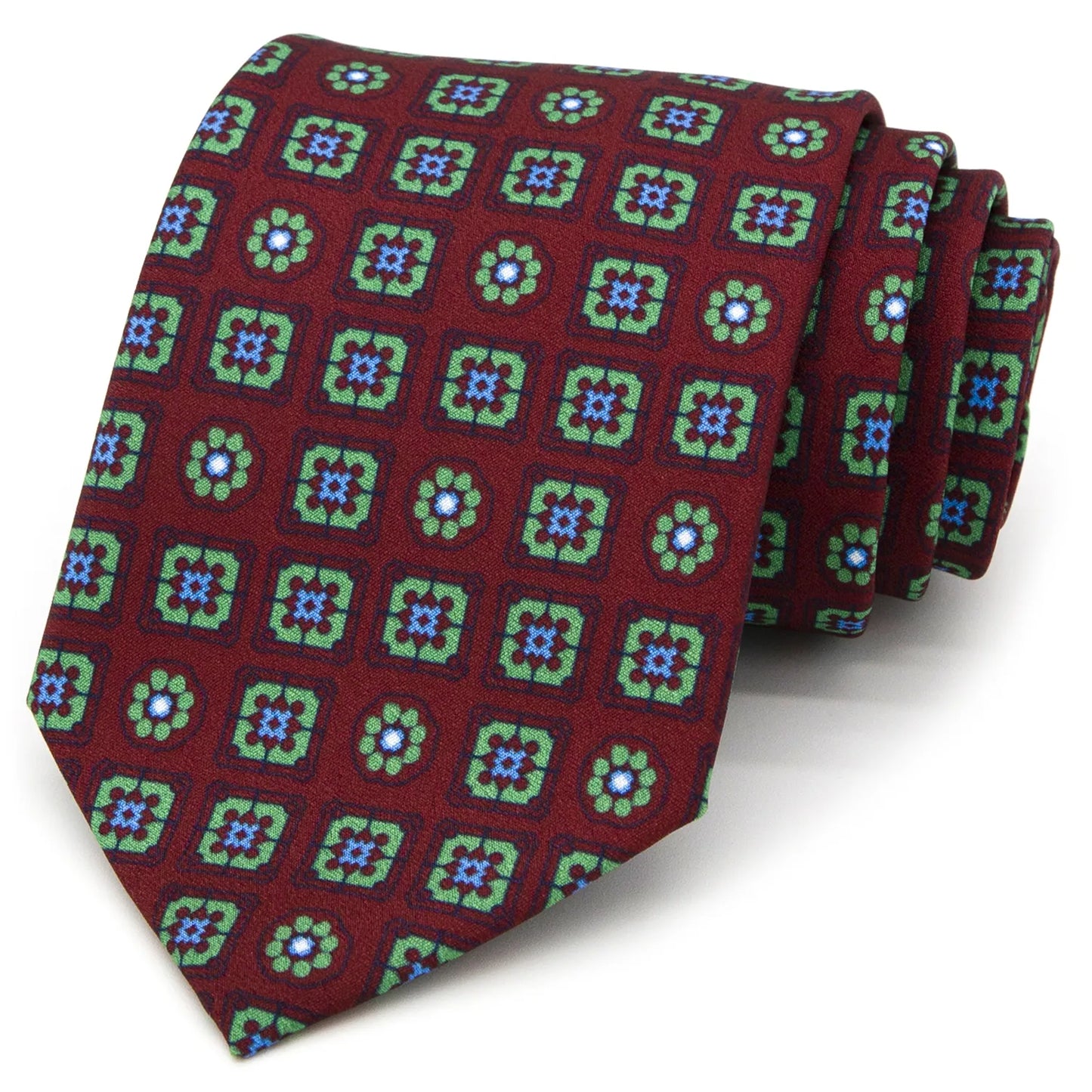 A burgundy men's necktie featuring a repeating pattern of small geometric squares containing floral motifs in green and blue is casually knotted against a white background.