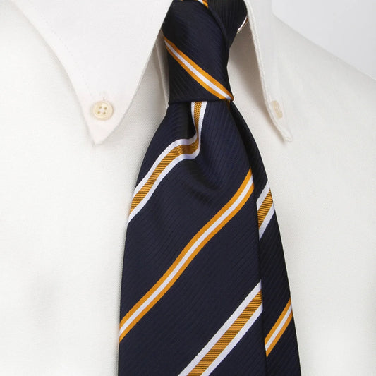 A neatly rolled deep blue men's necktie showcasing its striking diagonal stripe pattern in vibrant gold and crisp white against a clean white backdrop.