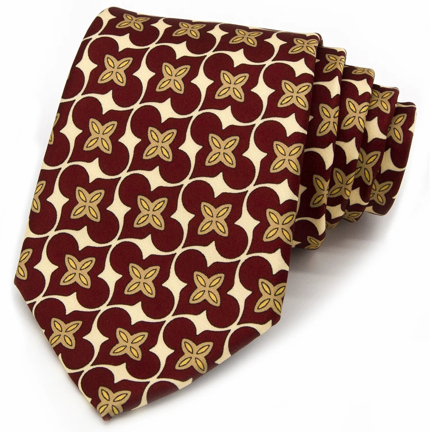 A neatly rolled deep red men's necktie showcasing its classic floral and curved geometric design in beige and gold against a clean white backdrop.