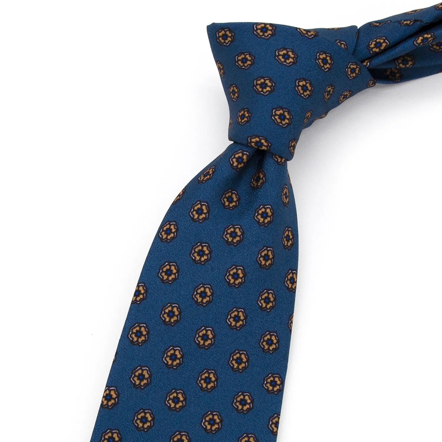 A blue men's necktie laid flat, displaying its repeating pattern of small brown and beige floral dots.