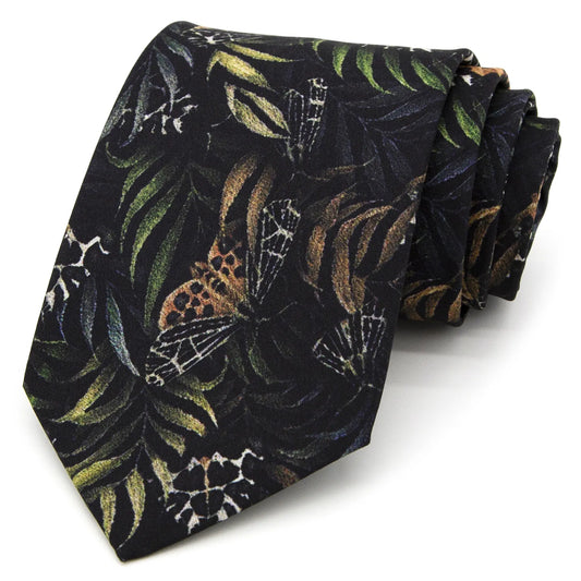 A dark black men's necktie featuring a unique pattern of brown, green, and beige butterflies and leaves is casually knotted against a white background.
