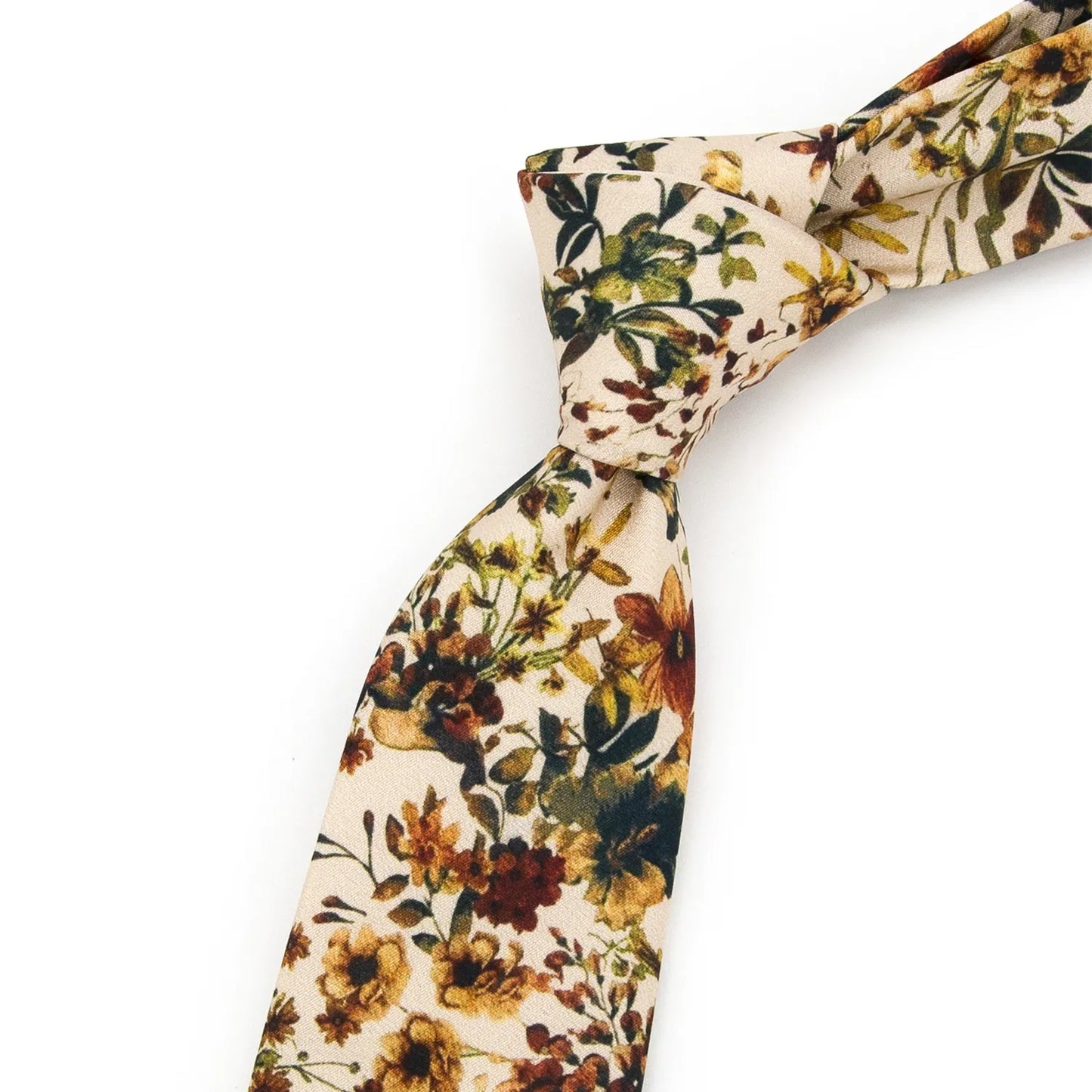 A neatly rolled light beige men's necktie displaying its soft floral pattern with brown, yellow, and green blooms and foliage against a clean white surface.