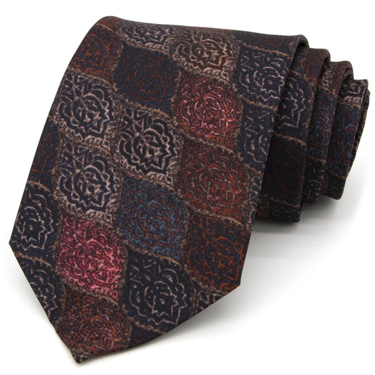A neatly rolled dark brown men's necktie displaying its vintage jacquard pattern with rich heritage motifs in red-brown, dark blue, and beige against a clean white surface.