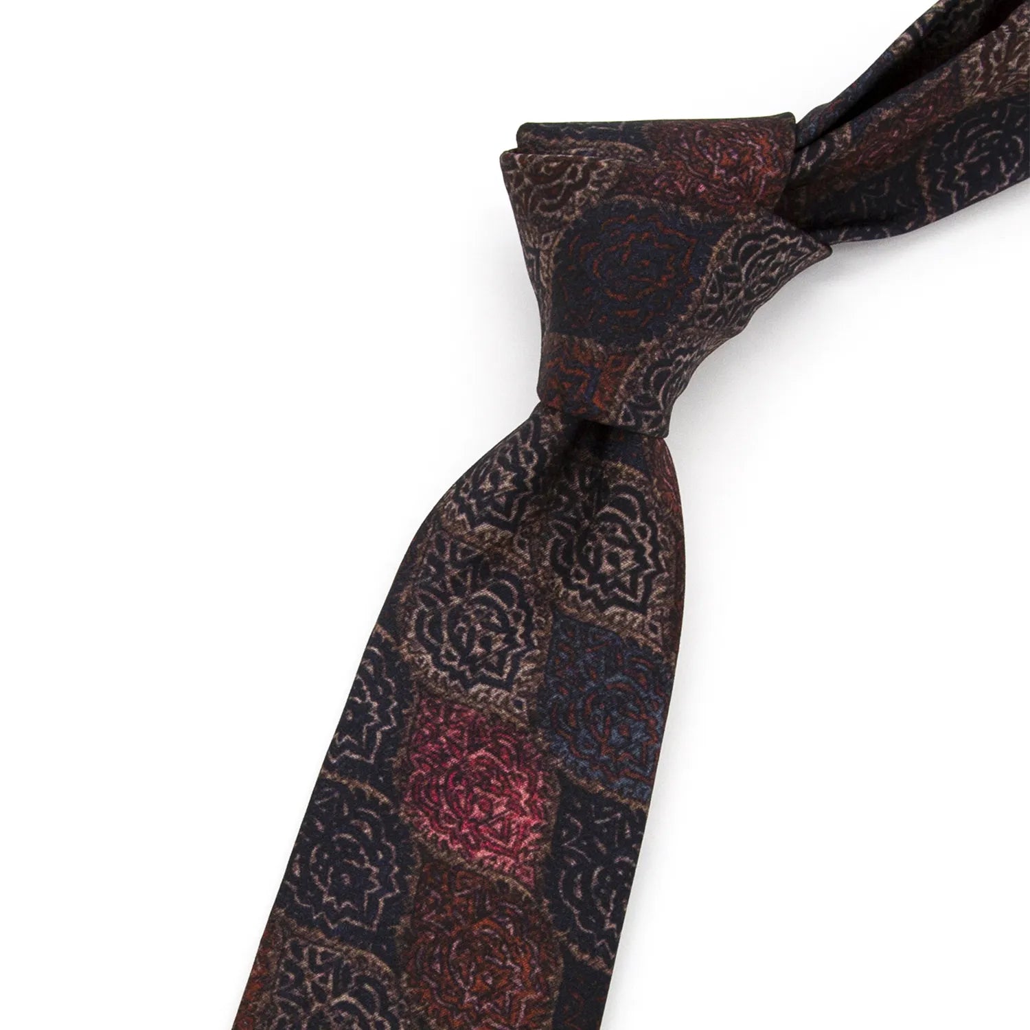 A dark brown men's necktie featuring a vintage jacquard pattern in shades of red-brown, dark blue, and beige is casually knotted against a white background.