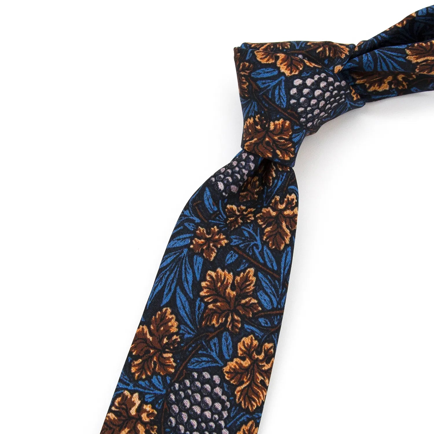 A dark blue men's necktie featuring a vintage grapevine and leaf pattern in shades of brown, blue, and light purple is casually knotted against a white background.