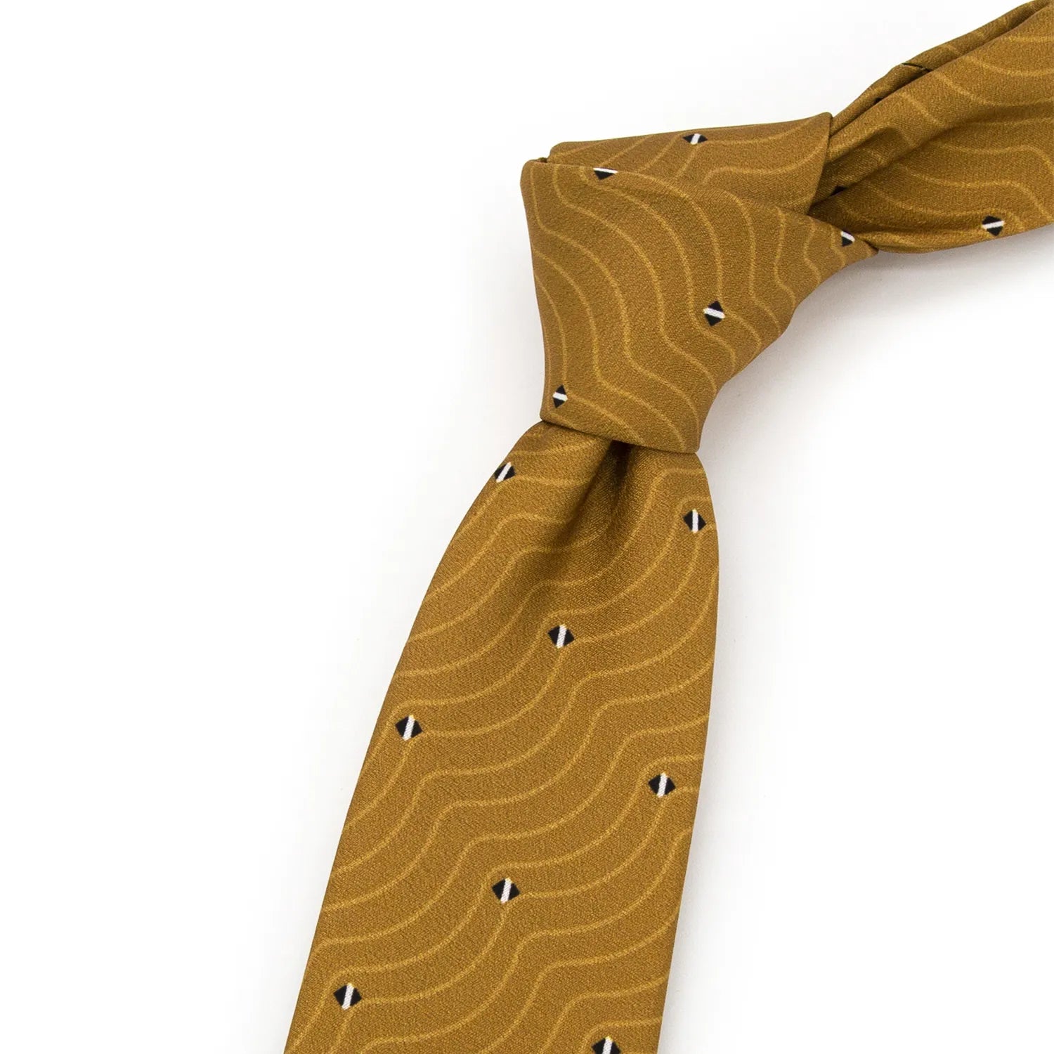 A neatly rolled gold and brown men's necktie displaying its subtle wavy line pattern in beige and small black and white diamonds against a clean white surface.