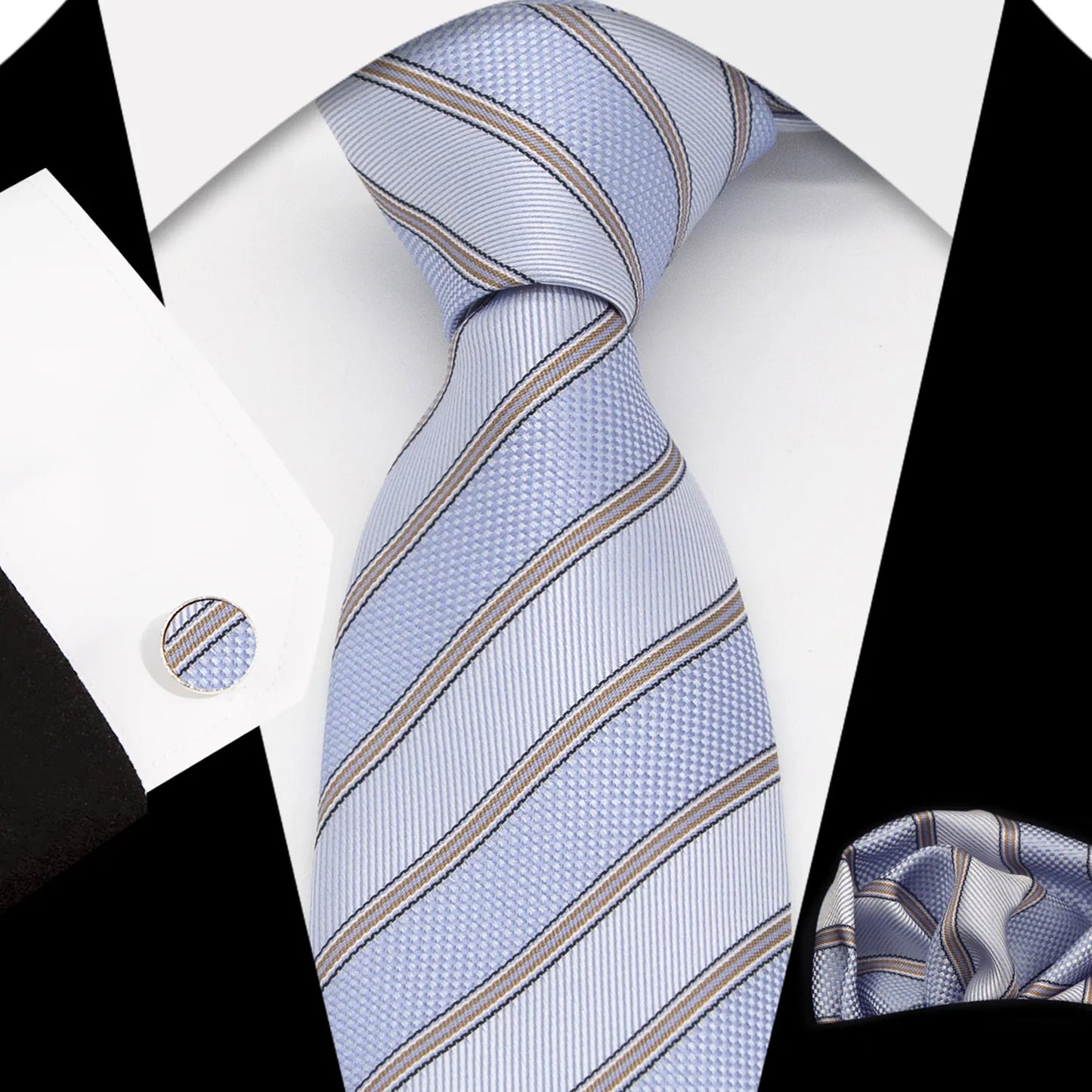 A complete men's tie gift box set, featuring a light blue-grey necktie with a subtle pattern of small dark blue and white dots, a perfectly matched pocket square, and a pair of sleek silver-toned cufflinks, elegantly presented for a sophisticated yet relaxed professional.