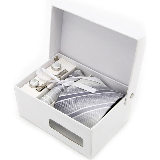 The XueDouLing Tie refined silver-grey tie set is meticulously arranged inside a gift box, showcasing the geometric patterned necktie, coordinating pocket square, and polished cufflinks, ready for gifting or immediate use.