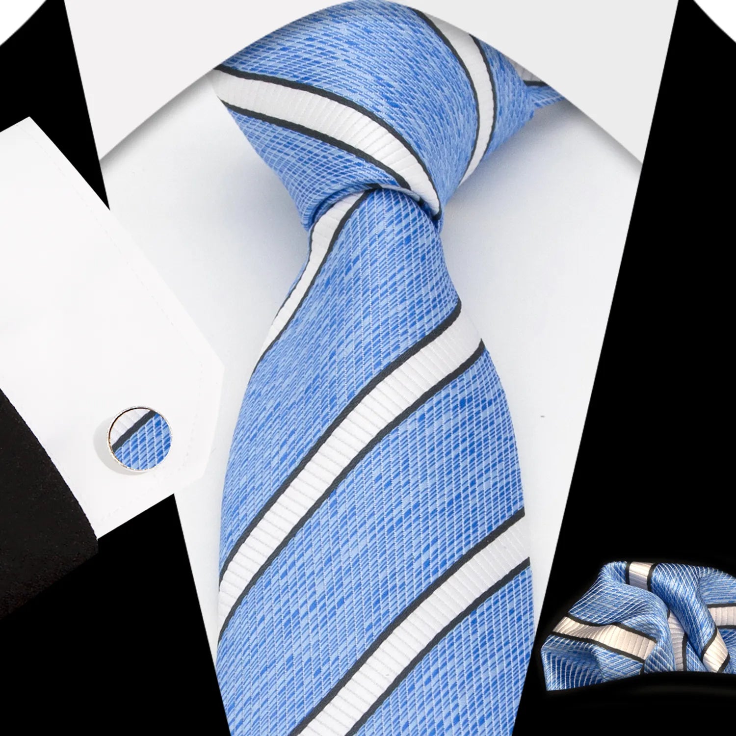 A complete men's tie gift box set, featuring a refreshing sky blue necktie with a subtle pattern of small dark blue and white geometric diamonds, a perfectly matched pocket square, and a pair of sleek silver-toned cufflinks, elegantly presented for a sophisticated yet relaxed professional.