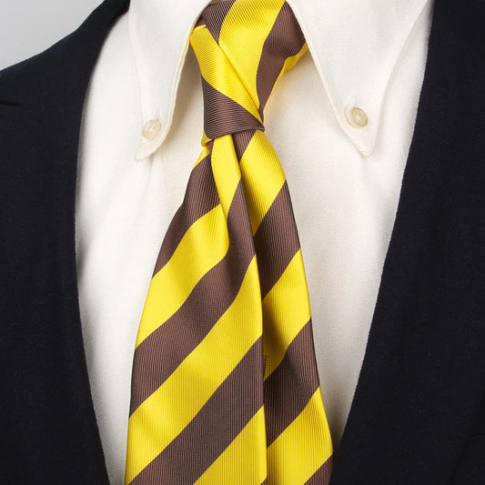 Full view of a luxurious men's tie displaying its refined diagonal stripes of vibrant yellow and warm brown highlighting the full pattern and quality of the fabric against a light background ready for wear