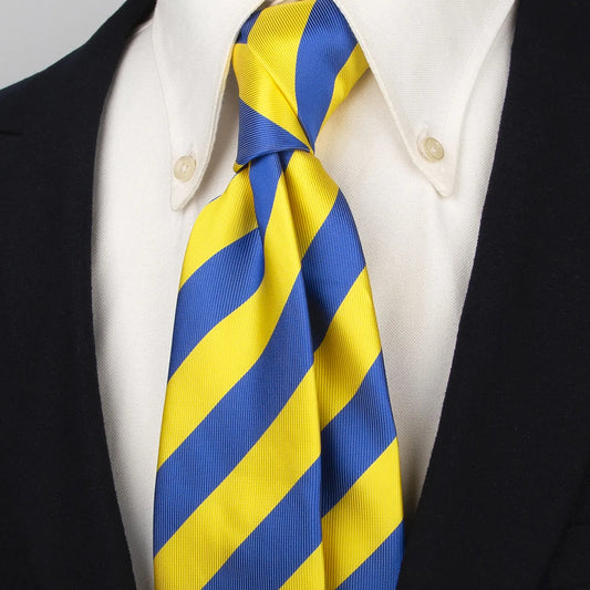 A vibrant blue and yellow striped polyester tie styled with a white collared shirt and dark blazer, illustrating its smart and eye-catching appearance on a person.
