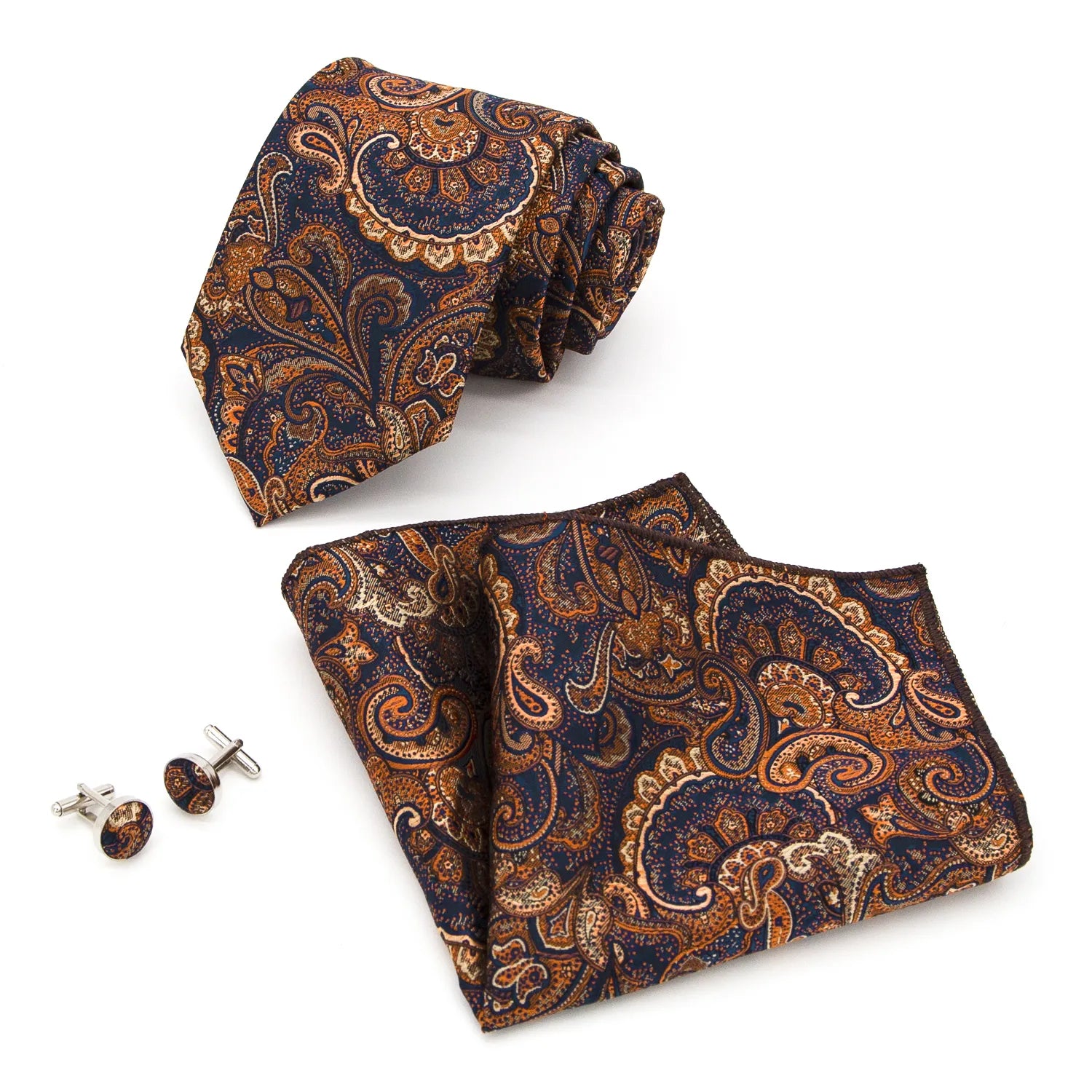A coordinated set featuring a rolled navy blue and orange paisley polyester tie, a folded matching pocket square, and two round cufflinks, all displaying an intricate pattern on a white background.