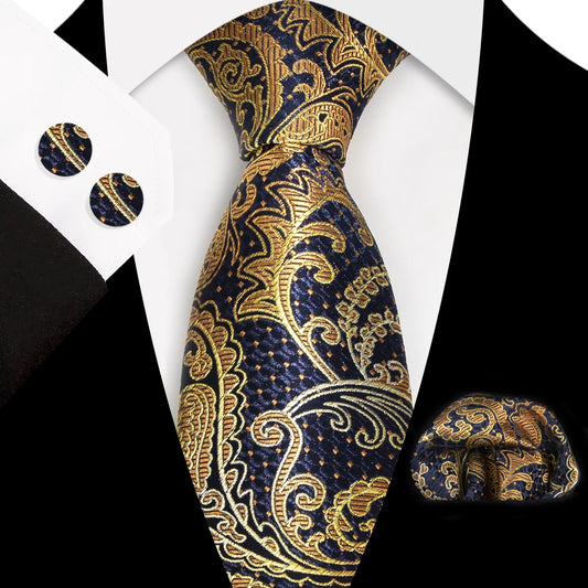A close-up view of a stunning navy blue and rich gold paisley patterned polyester tie, neatly tied, complete with a matching pocket square and cufflinks, styled for a formal occasion.