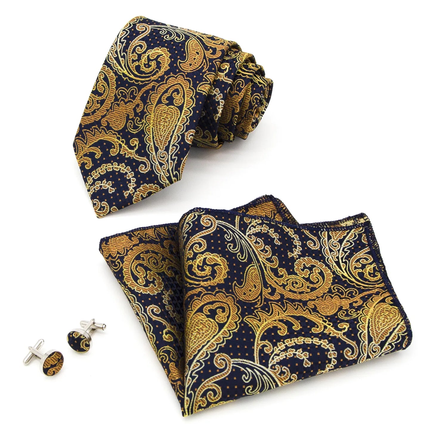 A coordinated set featuring a rolled navy blue and gold paisley polyester tie, a folded matching pocket square, and two round cufflinks, all displaying an intricate pattern on a white background.