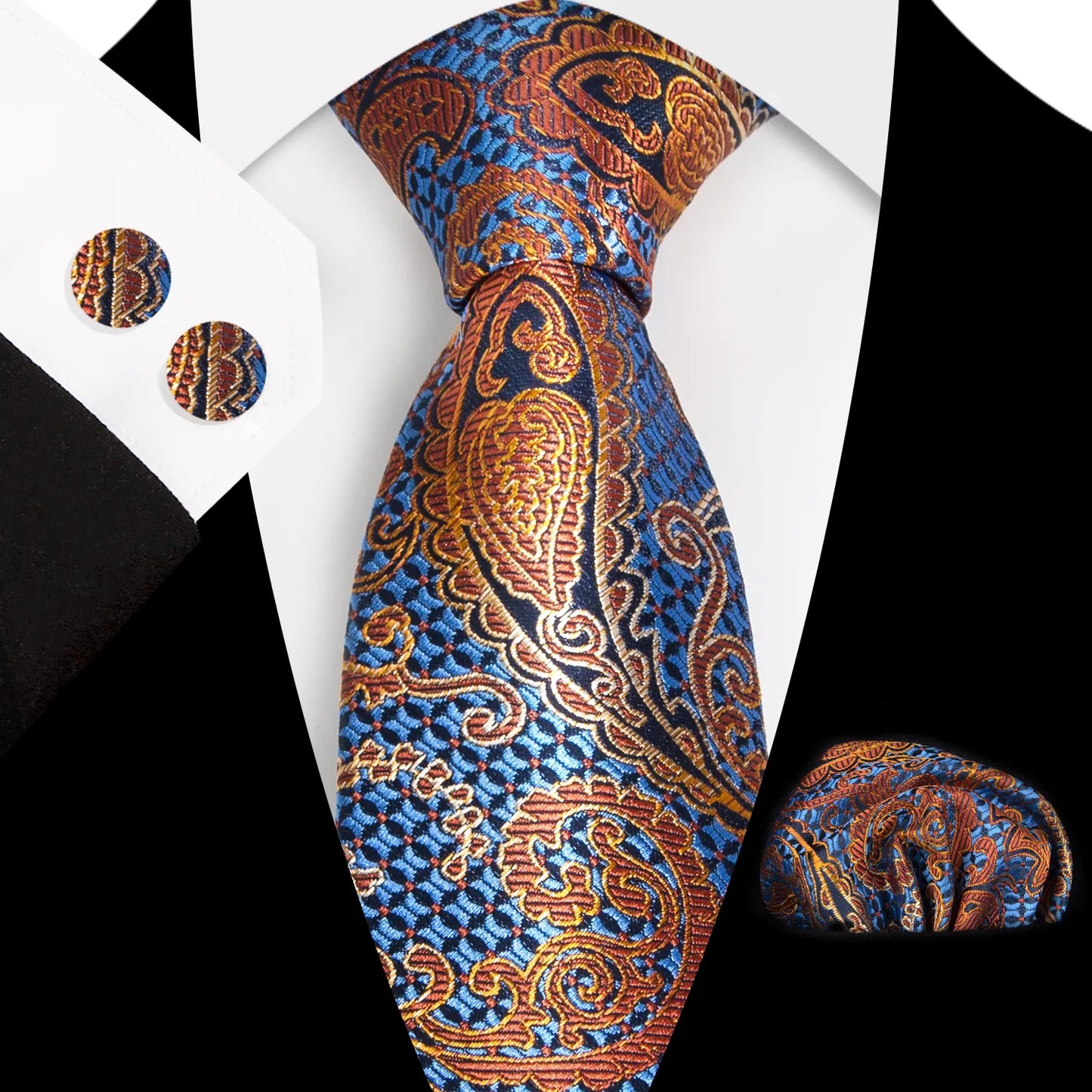 A close-up view of a striking blue and orange paisley patterned polyester tie, expertly knotted, complete with a matching pocket square and cufflinks, styled for a formal occasion.