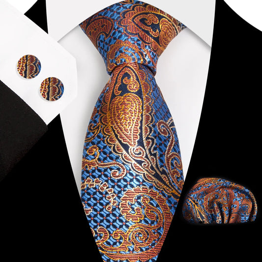 A close-up view of a striking blue and orange paisley patterned polyester tie, expertly knotted, complete with a matching pocket square and cufflinks, styled for a formal occasion.