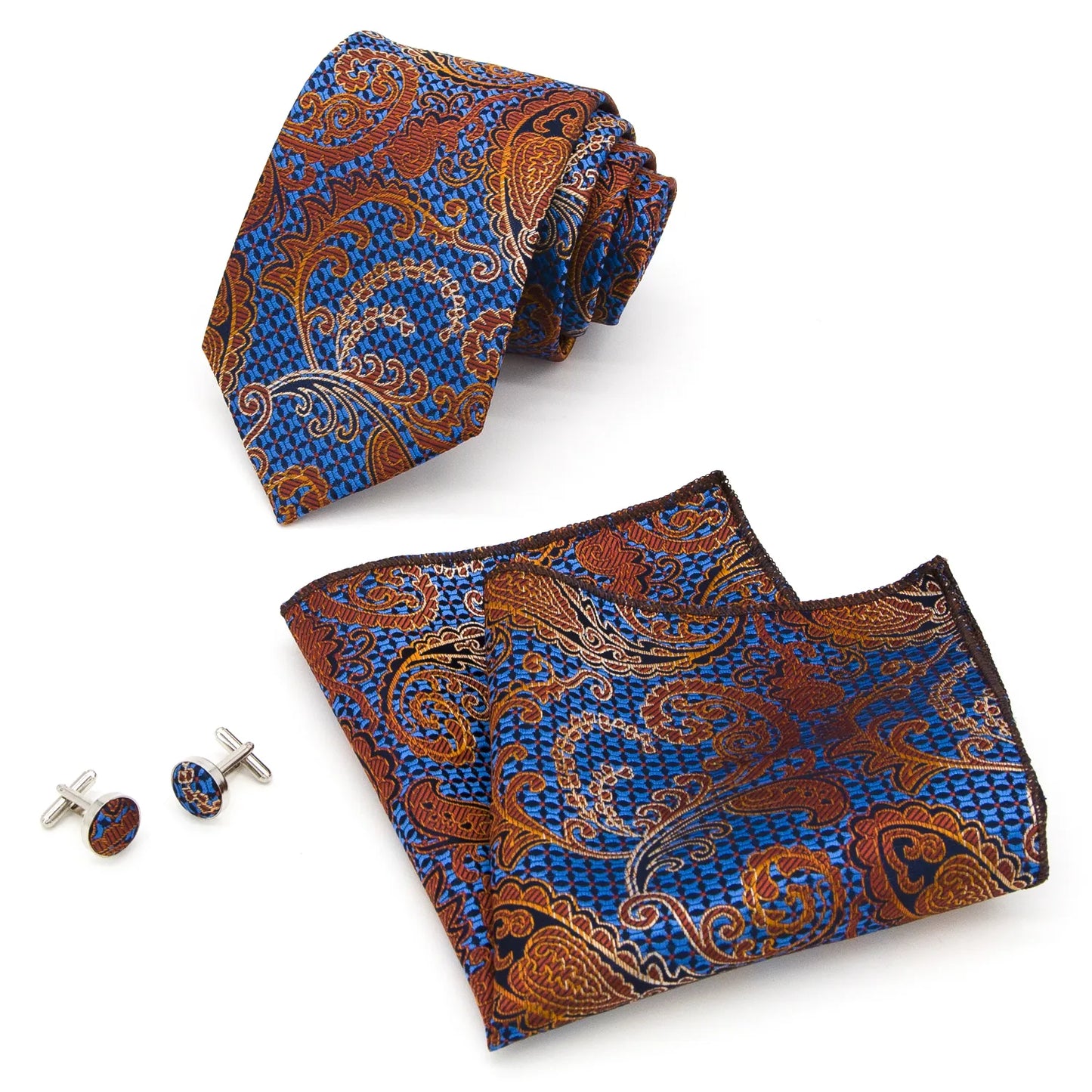 A coordinated set featuring a rolled blue and orange paisley polyester tie, a folded matching pocket square, and two round cufflinks, all displaying an intricate pattern on a white background.