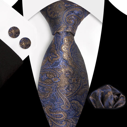 A close-up view of a sophisticated dark blue and bronze paisley patterned polyester tie, expertly knotted, complete with a matching pocket square and cufflinks, styled for a formal occasion.